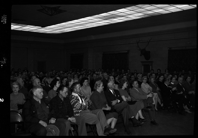 Crowd of unidentified men and women sitting in a room attending the Gyro Club Anti-Communism meeting.
