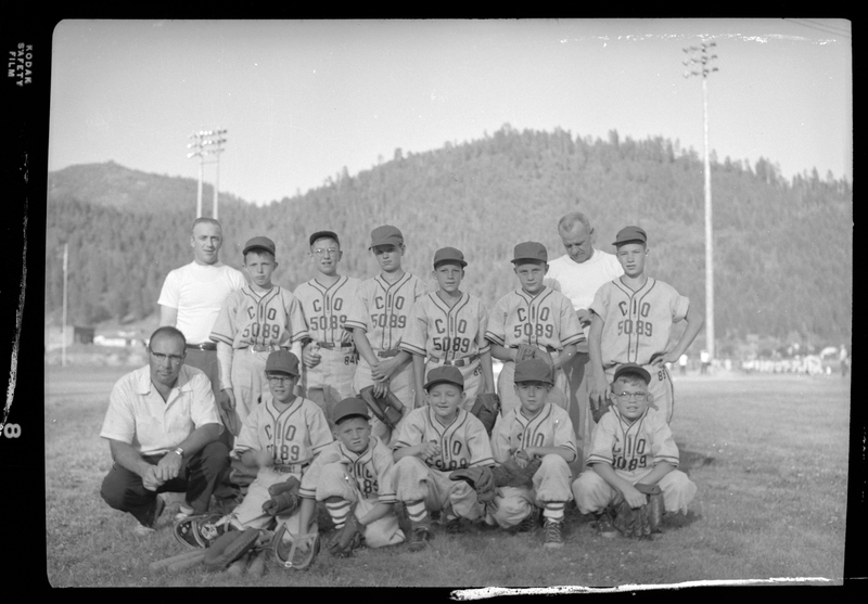 Group photo of the CIO Little League baseball team and their coaches. Front Row, from left to right: Coach Harold Goldstein (also the Principal of Wallace Junior High School), Tony Teske, Billy Hahn, Randy Gillies, Bill Teske, & (unknown). Back Row: Coach Tom Gillies, (unknown), (unknown), (unknown), Pete Zanetti, Paul Murray & (unknown). The coach in the rear right side is unknown. They are wearing matching uniforms and a few are holding baseball gloves. (Possibly Congress of Industrial Organizations).