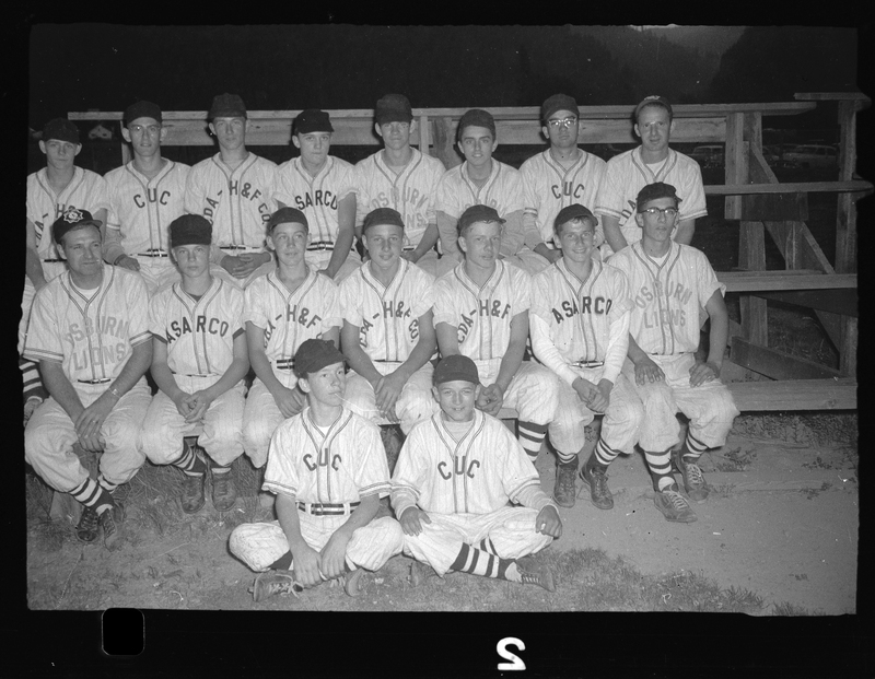 Photo of the Babe Ruth all-star baseball team posing for a photo on a set of bleachers. They are all wearing similar uniforms.