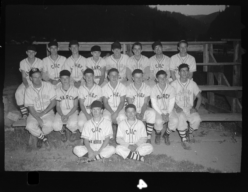 Photo of the Babe Ruth all-star baseball team posing for a photo on a set of bleachers. They are all wearing similar uniforms.