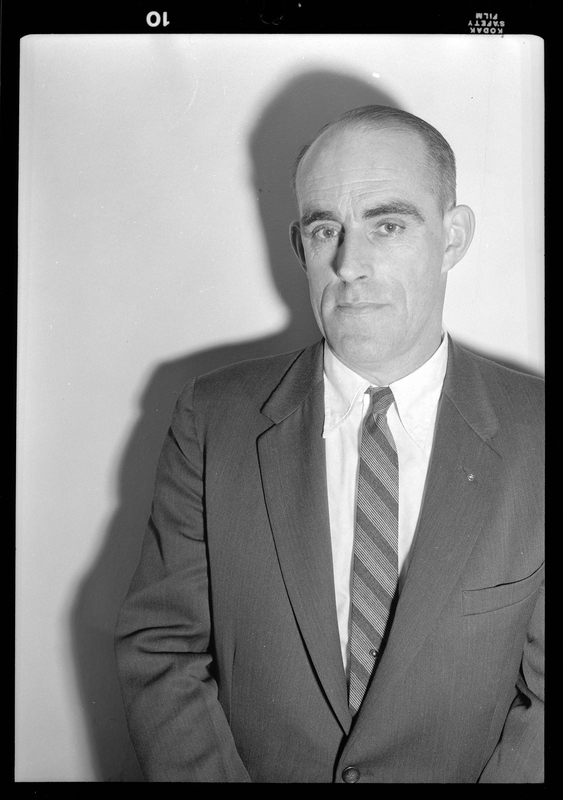 Photo of a man wearing a suit. Possibly Bill Featherstone.