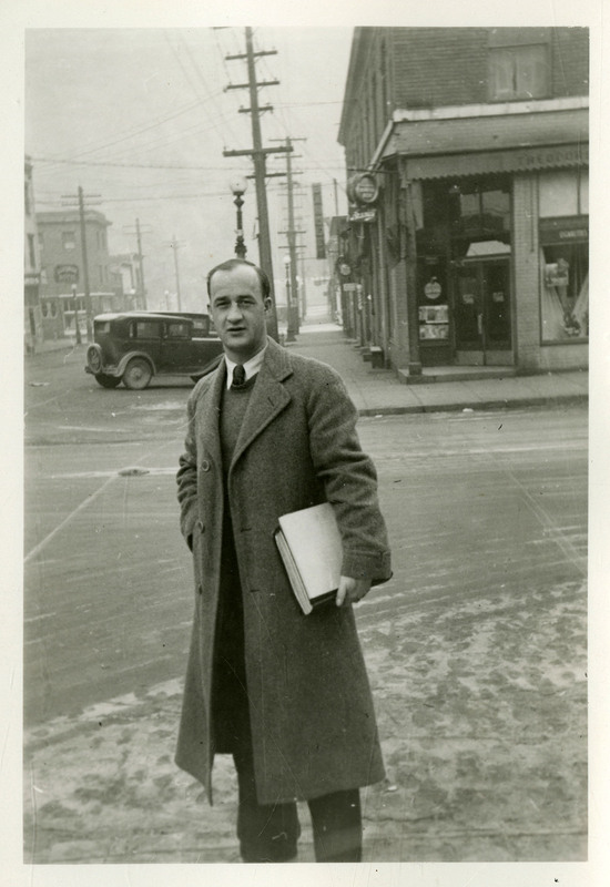 An unidentified man standing in front of the street.