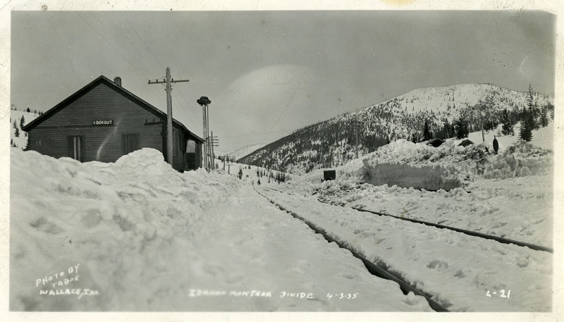 Snow almost entirely covers railway tracks and a building at the Idaho Montana Divide near Lookout Pass.`