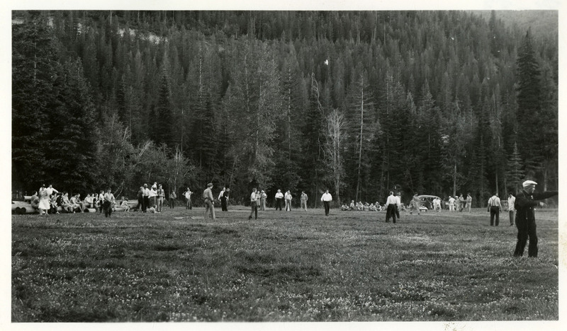 A crowd of people mill about a large field. Some of them are in police uniforms, others are in plainclothes. The handwriting on the photo lists several names: Lenney, [illegible], Glen, Mayor, [illegible], and Hester.