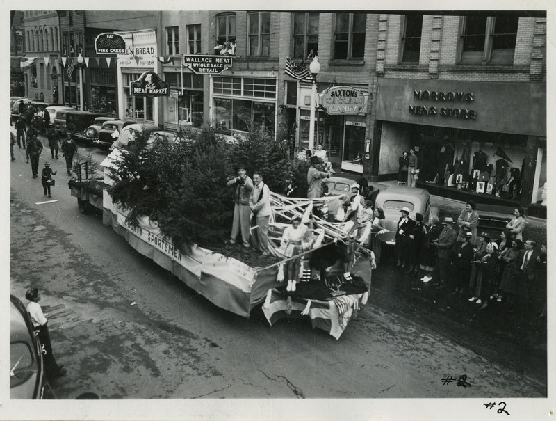 Several people stand on a float for the County Sportsmen in the Benevolent and Protective Order of the Elks parade.