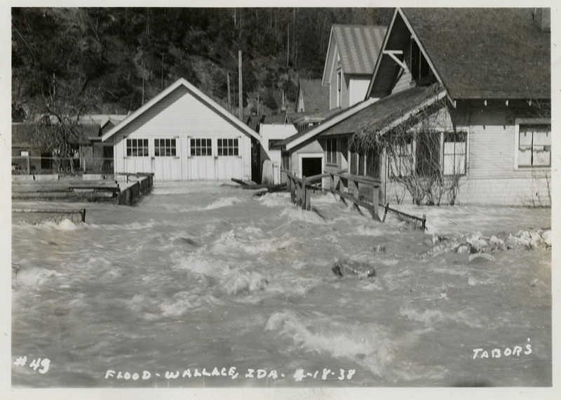 Water rushes past several buildings during a flood in Wallace, Idaho.