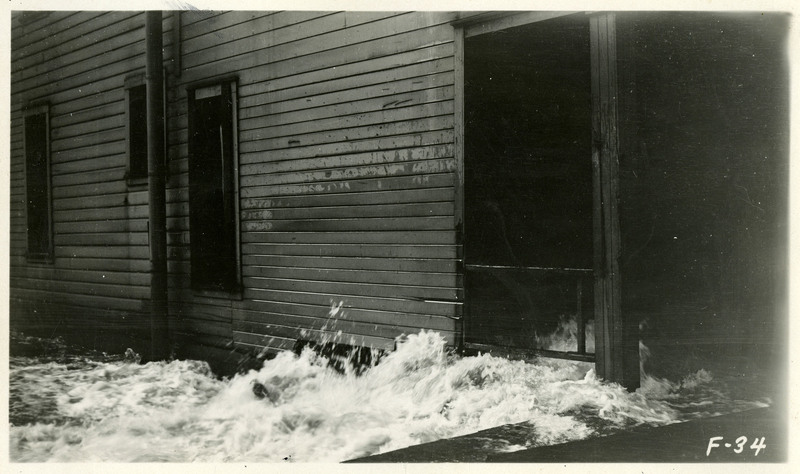 Flood waters crash against and into a building during the Wallace flood.