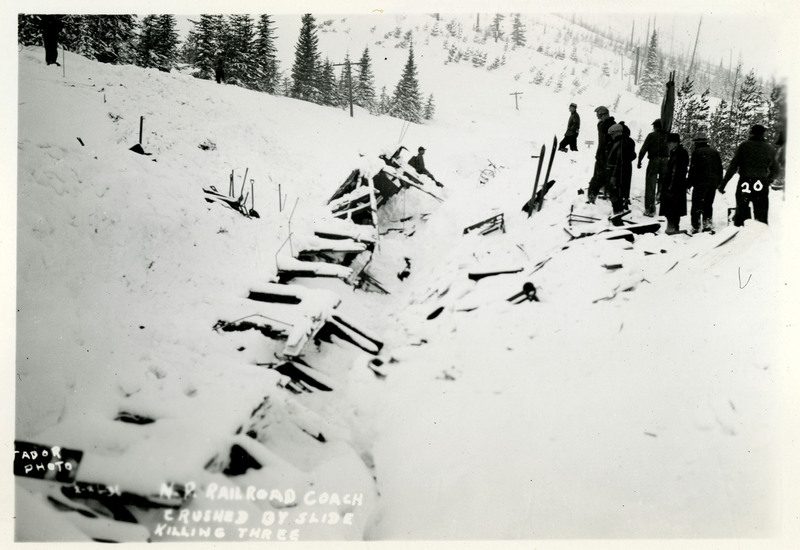 A group of people look at damaged railway tracks after the Northern Pacific slide. Three people were killed by the slide, according to the caption on the photo.