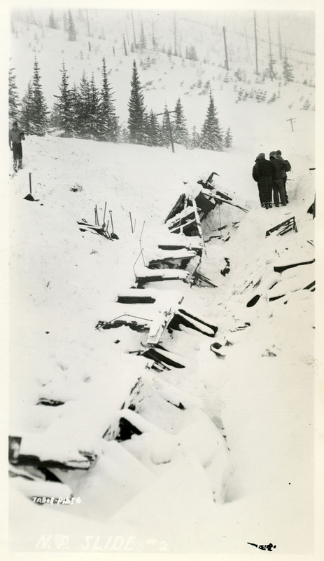 People stand near the debris left by the Northern Pacific slide.