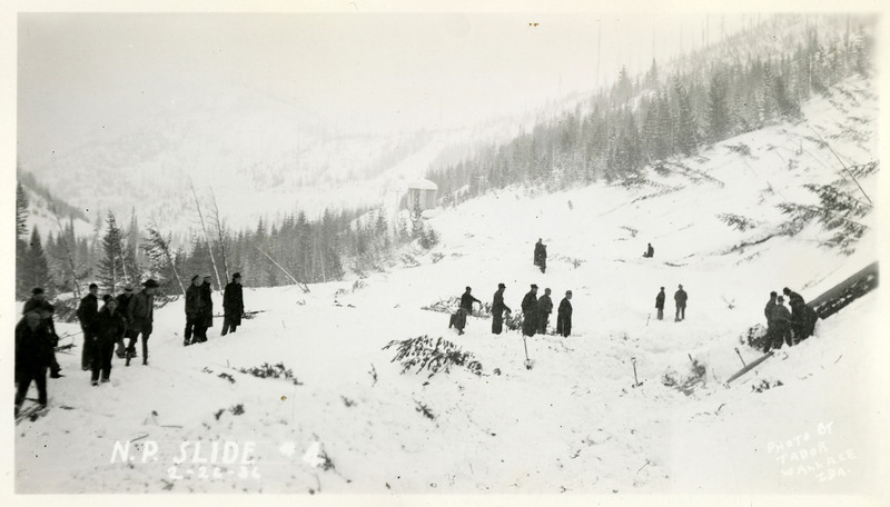 People follow each other across a snowy field after the Northern Pacific slide.