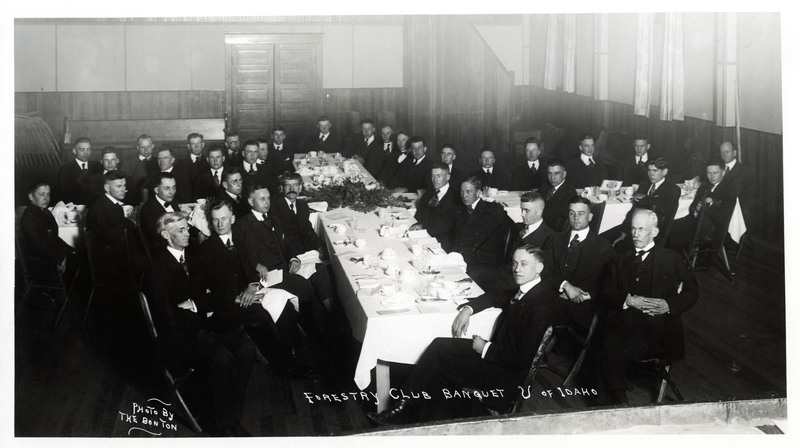 A picture of the Forestry Club Banquet at the U of I, with Dean Francis Miller against the wall at the right and possibly Clement Price to the left of the centerpiece (with mustache). 