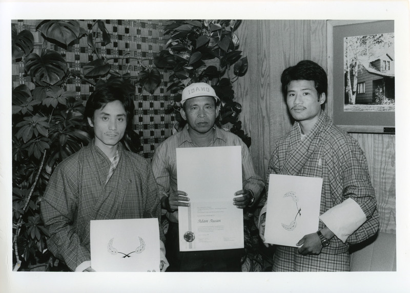 Karma Dhendup, Adam Ausan and Gem Tshering with t-shirts, hats and certificates of completion.