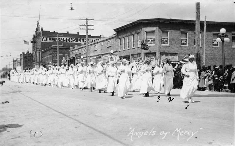 Photograph of Red Cross Volunteers marching in World War I parade Main Street, Moscow, Idaho.