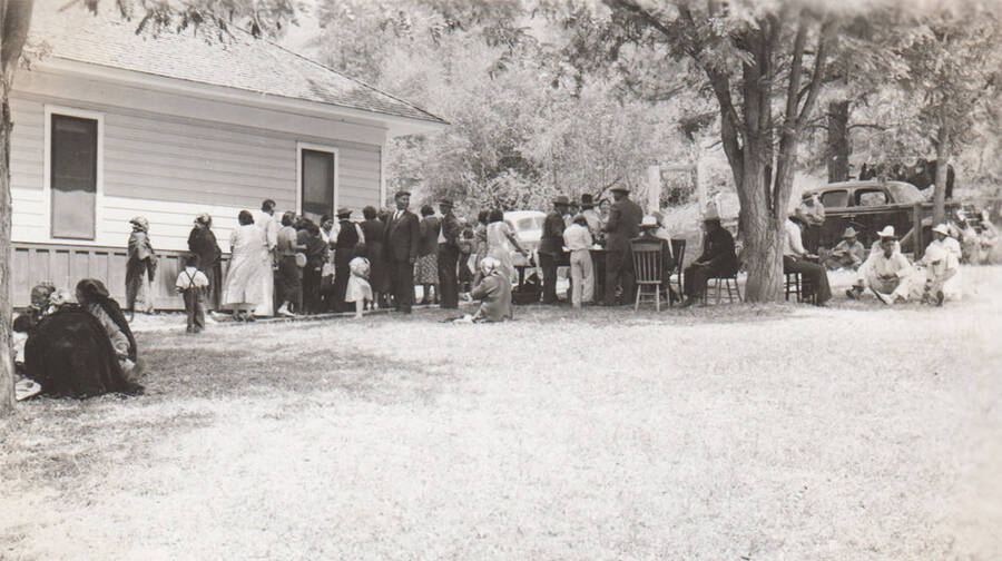 Photo caption: 'Kamiah Farm Chapter has all day meeting. Lunch is served at noon.' This image is part of a report regarding farm organizations among tribes in Northern Idaho and the CCC-Indian Division.
