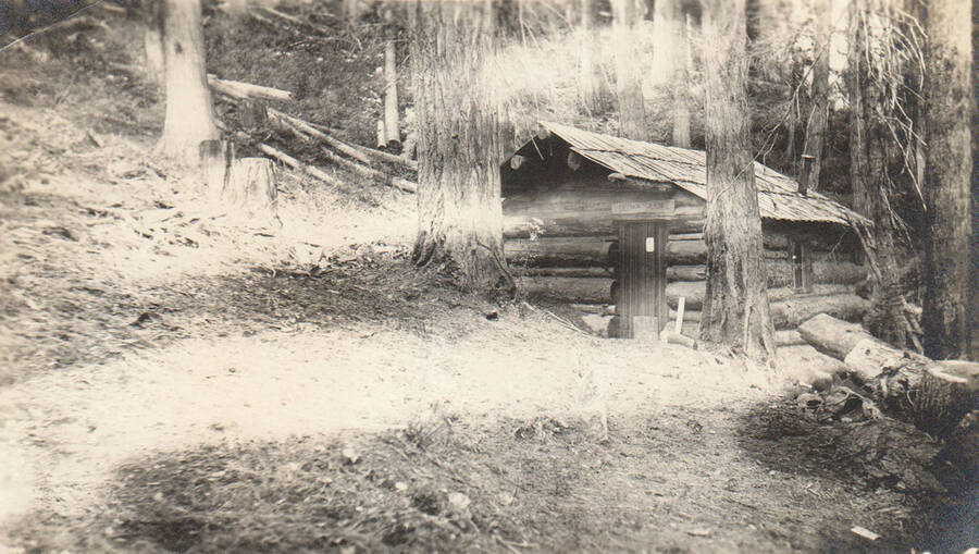 Photo text: 'Cabin in claim of May Agnes Russell. Located May 28, 1903. Photo, October 30, 1905. The schoolteacher type of homesteader, who spends portions of her 3 months summer vacation 'homesteading' here. Claim recently contested by scrip interests through Connolly Bros., timber dealers of Harrison, Idaho. Contest not yet heard. Presumably Connolly Bros. are attempting to force the homestead claimant to relinquish in their favor for some consideration.' Note: Marble Creek region homesteads at this time were often part of a homesteads fraud being documented by the US Forest Service.