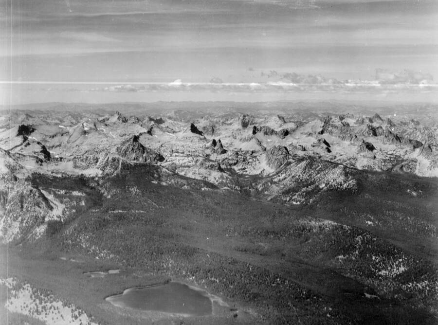 Photo caption: 'Taken from a position almost over Obsidian Post Office looking Northwest. Yellow Belly Lake in foreground. Large peak on left with several snow spots is Mt. Cramer. A little to the right is Elk Peaks.'