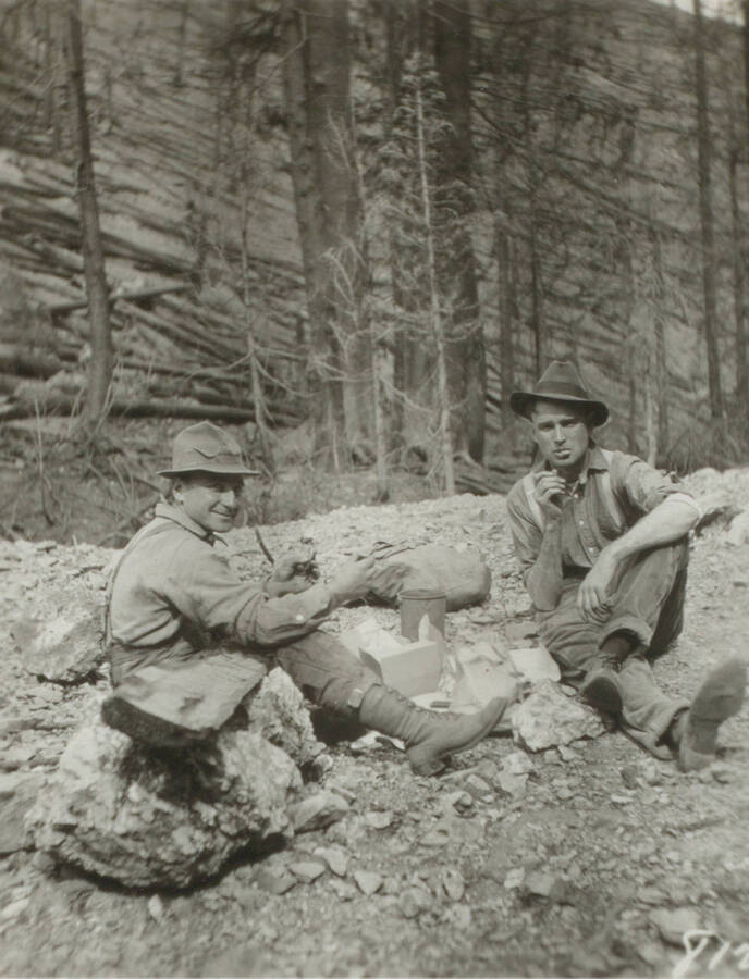 Photo text: 'Out getting pictures of fire with McKay.' This image is part of a pictorial narrative by William W. Morris titled 'Experiences on a National Forest'.