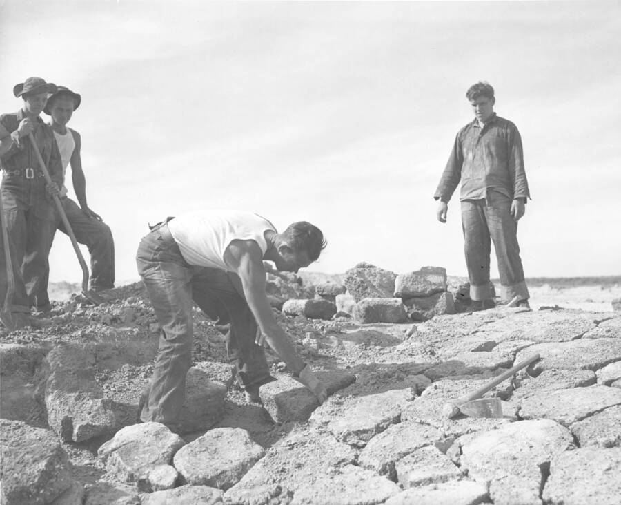 CCC workers from Mountain Home Camp G-99 set a stone incline. Likely a retaining slope wall. Image part of CCC-Idaho Indian Division.