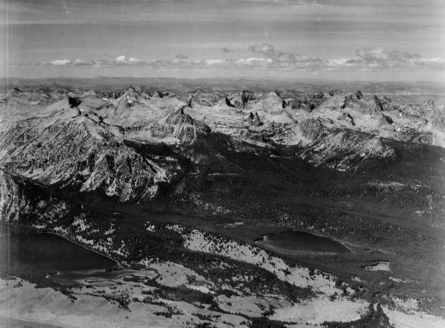 Photo caption: 'Taken from point over Sawtooth Valley about 3 miles east of Pettit Lake, looking northwest. In left foreground is Pettit Lake and to the right is Yellow Belly Lake.'