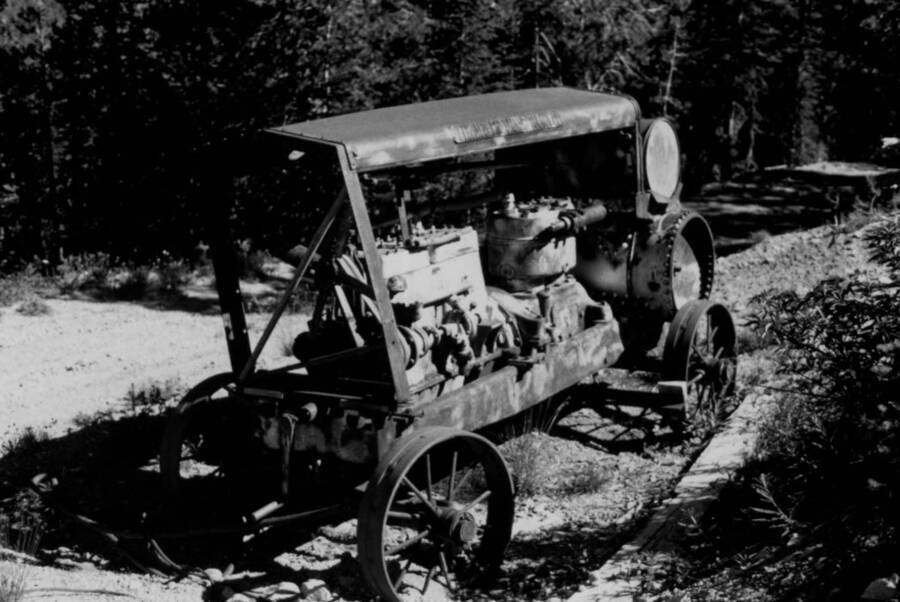 Photo text: 'Photo #20. An old Chicago Pneumatic Compressor parked near the Sheep Mountain Mine. Typical of some old machinery left by miners of yesteryear.'
