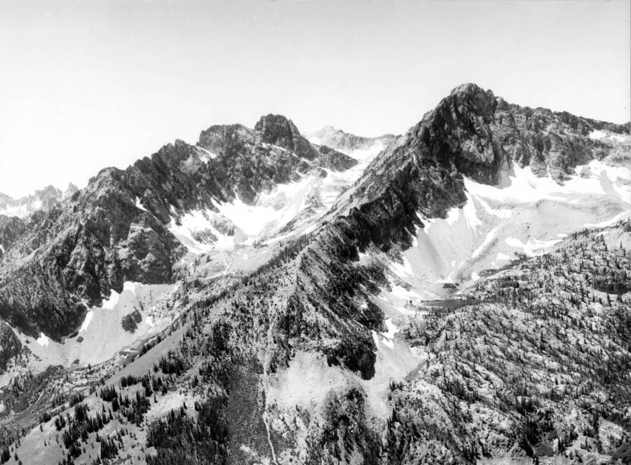Photo text: 'Thompson Peak is in the center left of photo. Prominent peak and lake on right have no official names.'