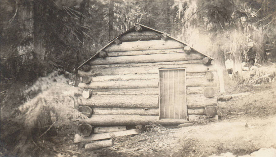 Photo text: 'Home of Joseph Russell on Marble Creek in fall 1905. Very little improvements, cultivation or clearing up to present time. He is still a claimant for this land, and is now employed as a Railway mail Clerk working out of Spokane, Washington. An attempt to secure valuable timber land under homestead laws without even a colorable showing as to residence, cultivation or improvements. Purely a speculative venture. See his testimony before the Idaho Legislative Homestead Committee.' Note: Marble Creek region homesteads at this time were often part of a homesteads fraud being documented by the US Forest Service.