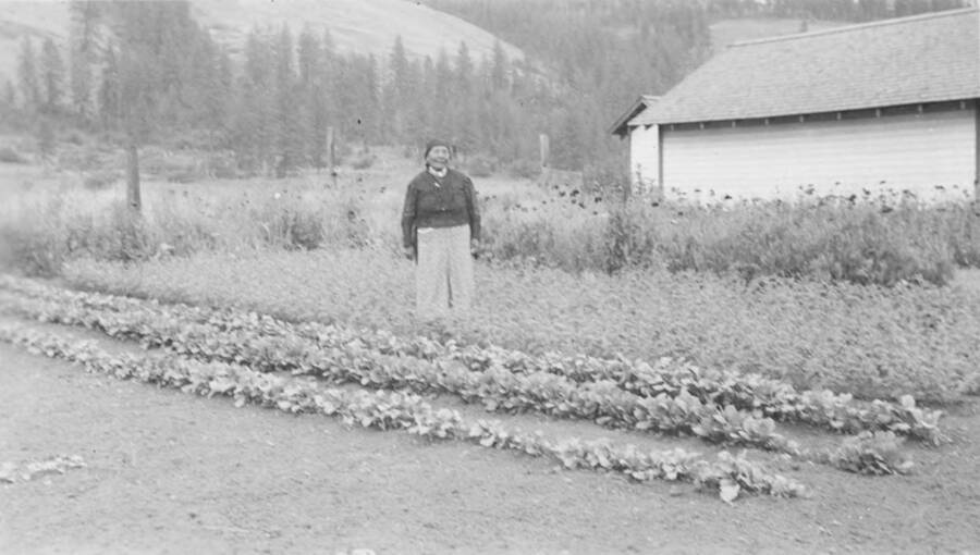 Photo caption: 'Madeline Lawry has a small but well kept garden at her home near Kooskia.' This image is part of a report regarding farm organizations among tribes in Northern Idaho and the CCC-Indian Division.