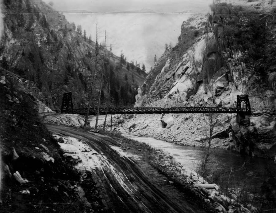 Photo text: 'The Cevice (Manning) suspension bridge - 14 miles above Riggins on the Salmon River - constructed by CCC, 1934.'