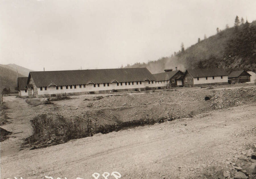 Photo text: 'Camp and construction scenes at Wallace Flood Camp to dredge and straighten channel of Coeur d'Alene River. Single men's camp.' Note: This image is part of a Work Progress Administration publicity series.