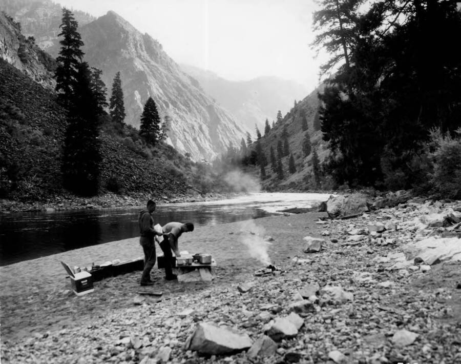 Photo text: 'Early A.M. at Stoddard Campground. Breaking camp, ready for the last leg of the float trip down Middle Fork of Salmon River. Wild Rivers Study. July 29, 1964.'