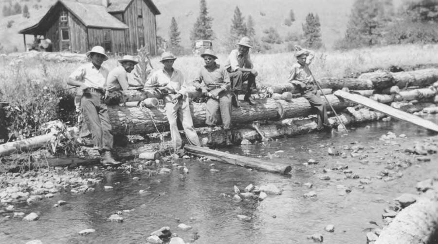 Photo caption: 'These boys expect to keep this steam within its natural channel.' This image is part of a report regarding farm organizations among tribes in Northern Idaho and the CCC-Indian Division.
