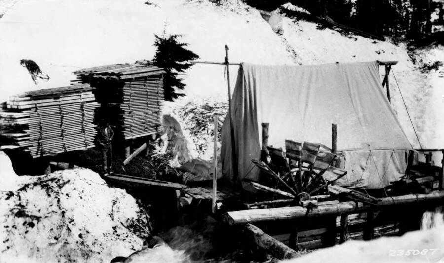 A man standing next to a sawmill at the Elk Summit Ranger station in the Clearwater National Forest.