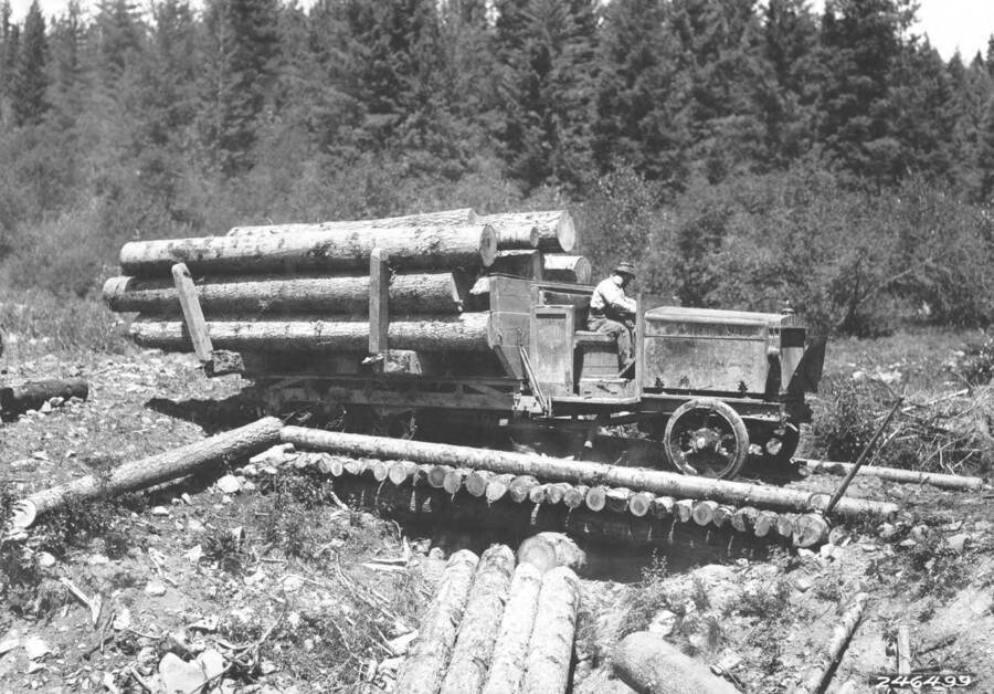 Photo text: 'Near Clearwater Forest. Linn Caterpillar truck with load at landing below Pierce, Idaho.'