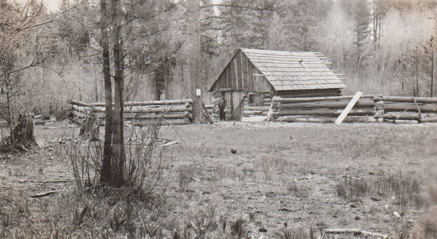 Photo caption: 'Art McConville lives in this cabin. It is located on the Tribal Reserve which he has leased, and he is farming 125 acres of Tribal land.' This image is part of a report regarding farm organizations among tribes in Northern Idaho and the CCC-Indian Division.