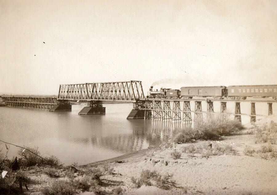 Photo text: 'Bridge over Snake River at Heyburn, Idaho, with train passing. Looking in westerly direction.' Note: This image is part of records for Bureau of Reclamation projects.