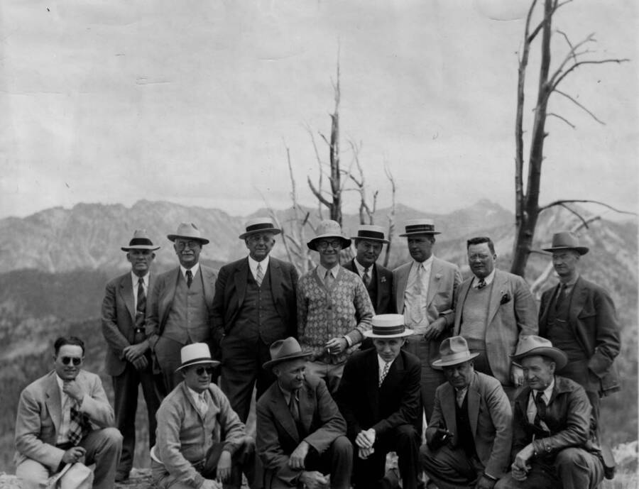 Photo text: 'Left to right kneeling. Clark Heise, R.P. Carry, acting supervisor E.E. Mckee of Challis Forest, F. Melia, Assistant of President Gray, Harry Shellworth, member of Chamber of Com. and Vice President of the Boise Payette Inc. and Claude Gillespie. Standing: C.N. Woods, associate regional forester, R. E. Shepherd, President of Idaho State Chamber of Cam., Carl. R. Gray, President of U.P. System, Mr. Paul, owner of Idaho Rocky Mt. Club, J.E. Haugh, assistant to president Gray, J.A. Seitz of the U.P. office of Salt Lake, E.C. Schmidt, assistant to President Gray and F.S. Moore, Supervisor of the Sawtooth [Challis?]'