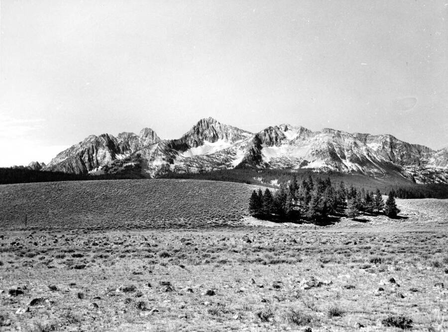 A photograph of Route 21, 3 miles south of Stanley, with the Sawtooth Range in background.