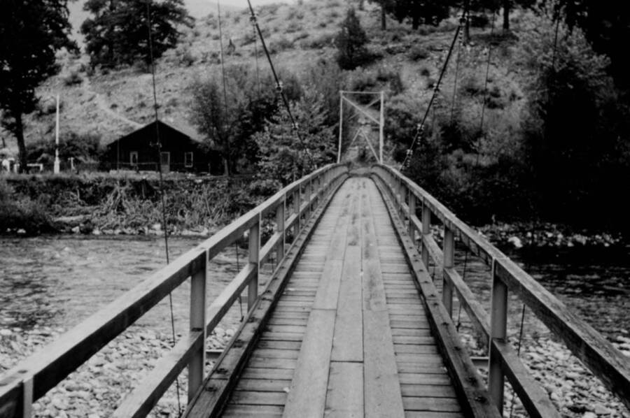 Photo text: '#24. The Little Creel Bridge across the Middle Fork of the Salmon River. Little Creek Guard Station, Challis National Forest, across the river.'