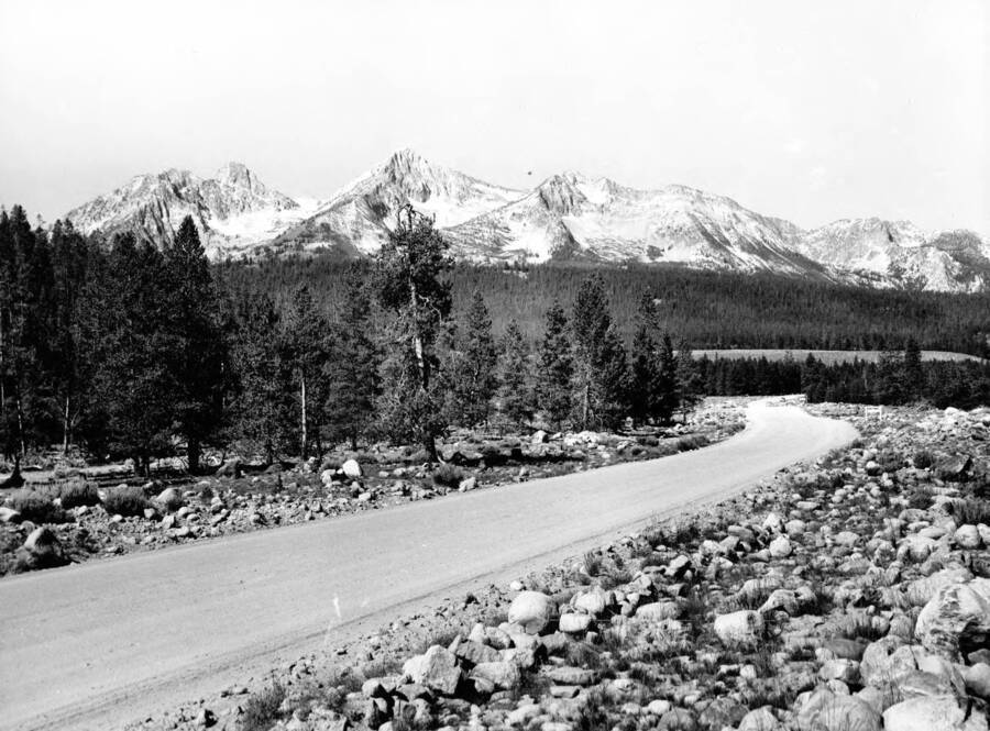 A photograph of Route 21, 4 miles north of Stanley, with the Sawtooth Range in background.