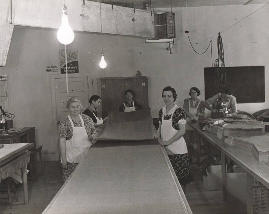 Photo text: 'Boise, Idaho, unit of the WPA sewing project, showing the cutting room, where goods are cut and shipped to all other sewing units in the state.' Note: This image is part of a Work Progress Administration publicity series.
