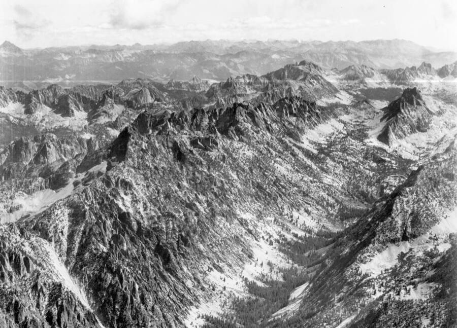 Photo caption: 'Looking east from a position over the point on ridge between Goat Creek and South Fork of Payette River. Main drainage in foreground is Goat Creek. Other peaks showing are Branson Peal, Tohobit Peak, Warbonnet Peak, and Red Fish Peak.'