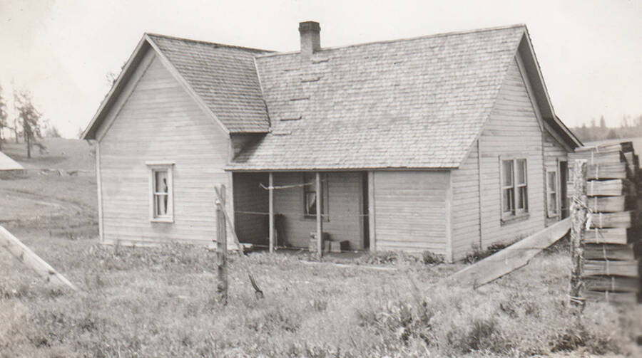 Photo caption: 'This house of Agnes Loury is to be repaired both inside and out.' This image is part of a report regarding farm organizations among tribes in Northern Idaho and the CCC-Indian Division.