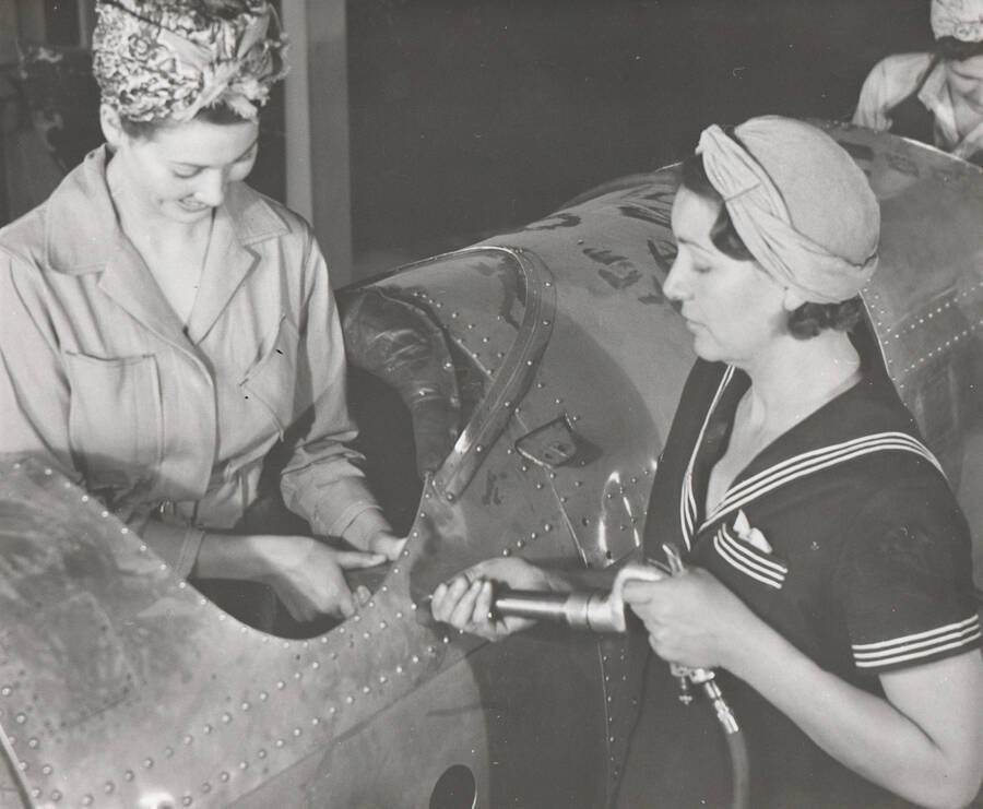 Photo text: 'Riveting, drill press operation, and other skills used in aircraft manufacture, are being taught WPA women trainees in Boise, Idaho, shops in a project sponsored by the U.S. office of Education and (Locally) the Idaho department of Vocational Education.' Note: This image is part of a Work Progress Administration publicity series.