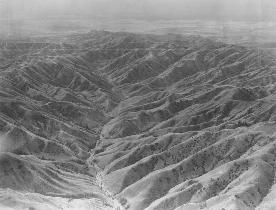 Photo text: 'From position over Arrow Rock Dam, Idaho, looking south at the rolling sagebrush covered hills near Boise, Idaho.' This image is part of a series of aerials taken by the Army Air Corps.