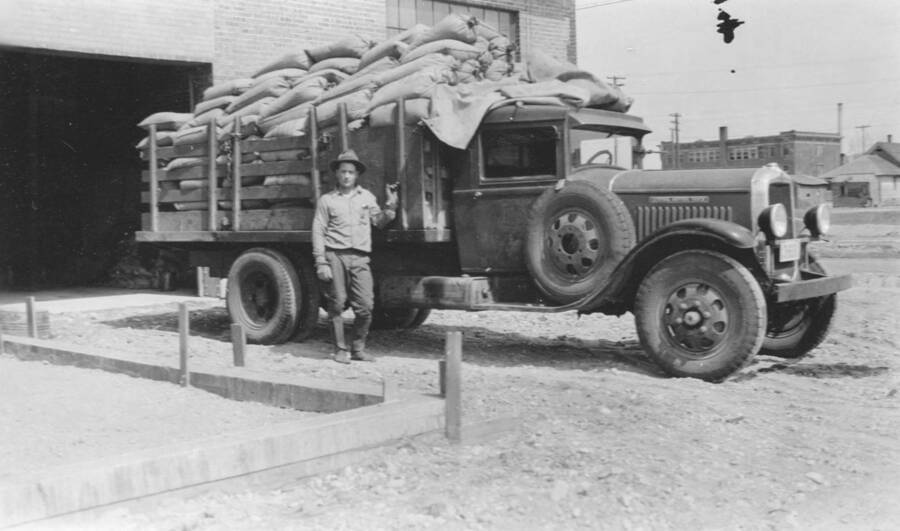 Photo text: 'United States Forest Service truck with eleven thousand pounds bait in fifty pound bags.' This image is part of a report by the United States Department of Agriculture Biological Survey on predation and pests.