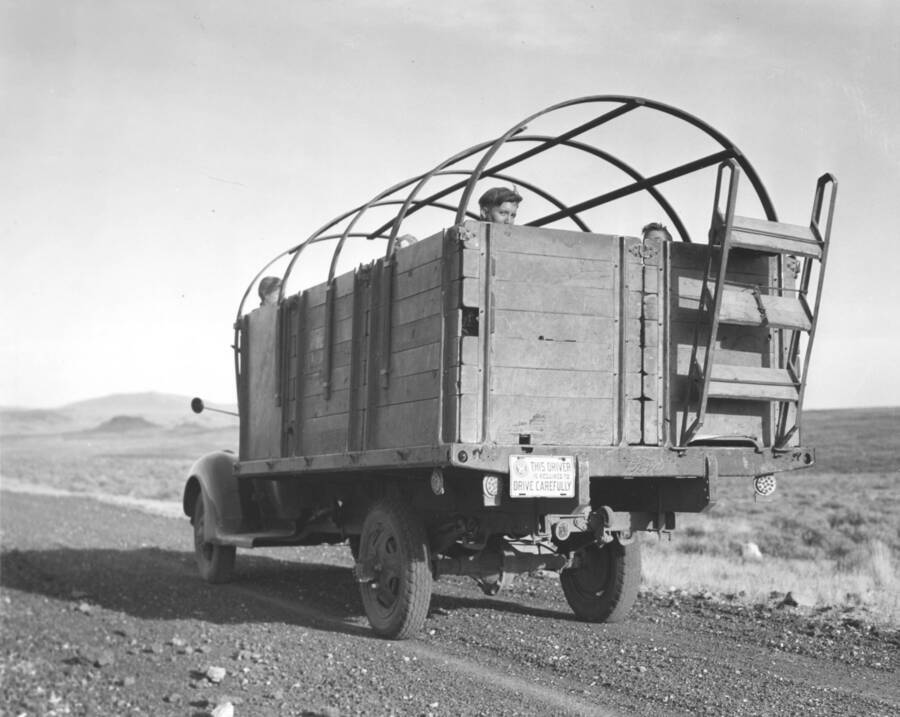 A CCC work transportation truck. A worker from Mountain Home Camp G-99 peeks over back. Image part of CCC-Idaho Indian Division.