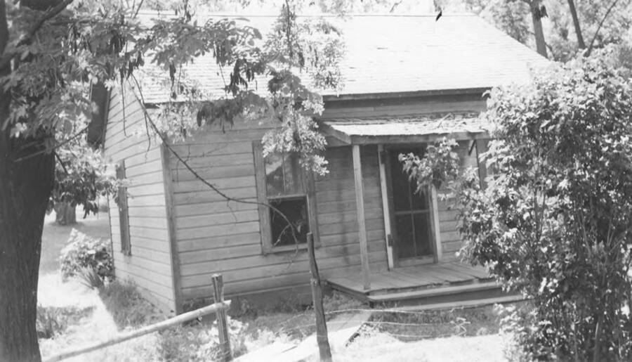 Photo caption: 'Another view of Conley Seth home. Front view. Before work started.' This image is part of a report regarding farm organizations among tribes in Northern Idaho and the CCC-Indian Division.