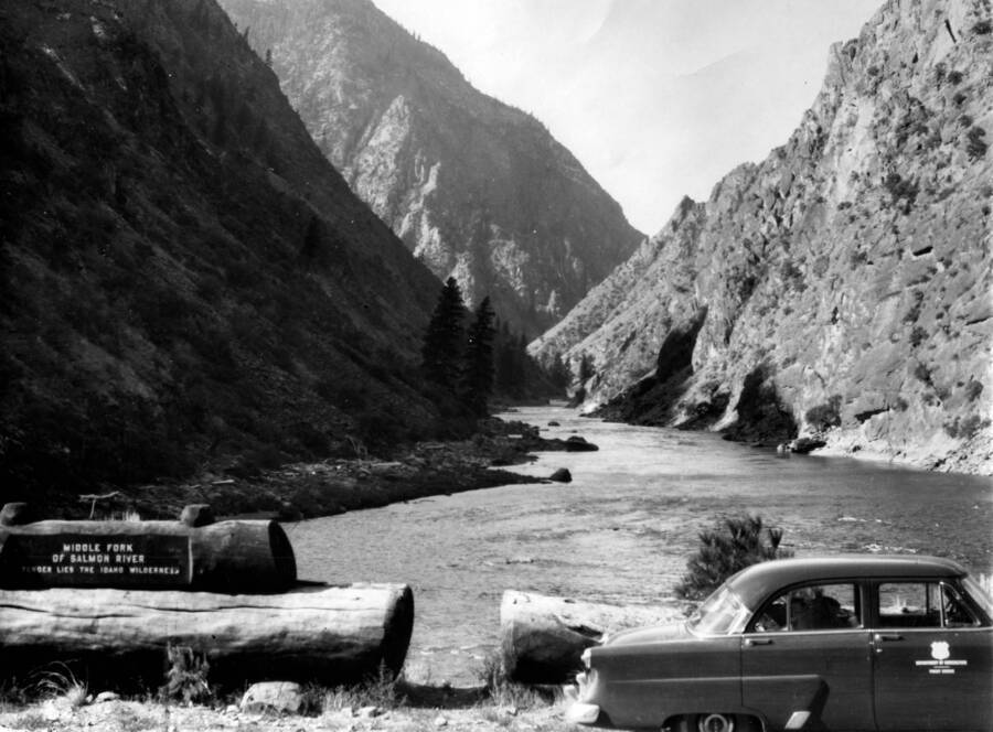 Sign to left of image reads: 'Middle Fork of Salmon River -- Yonder lies the Idaho Wilderness'