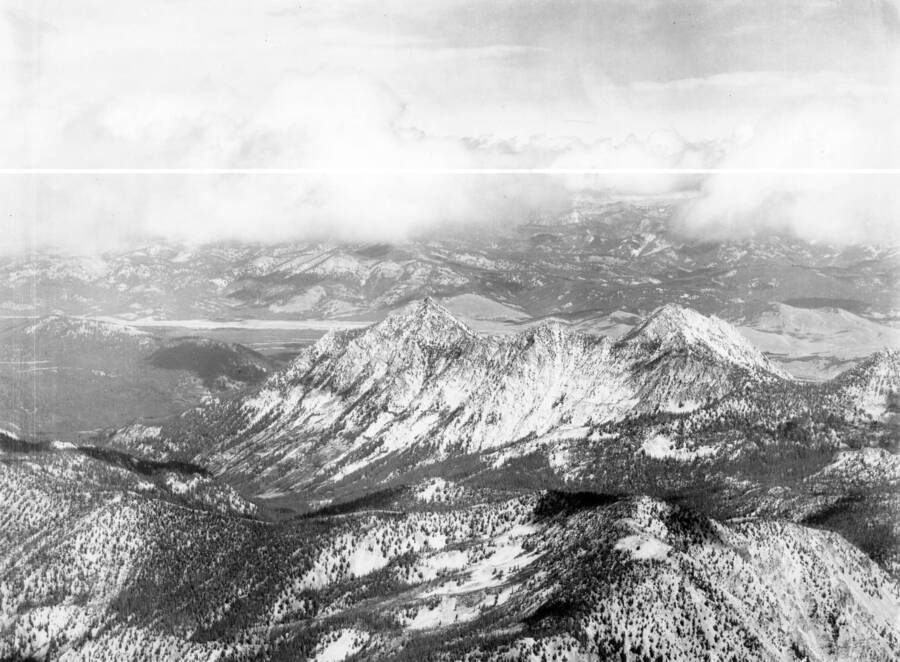 Photo caption: 'Taken from a position over Silver Creek looking N.E. Peak in the center is McGowan Peak. Valley in distance is Stanley Basin. Drainage this side of McGowan is Stanley Lake Creek. Mountain in low right is Observation Peak.'