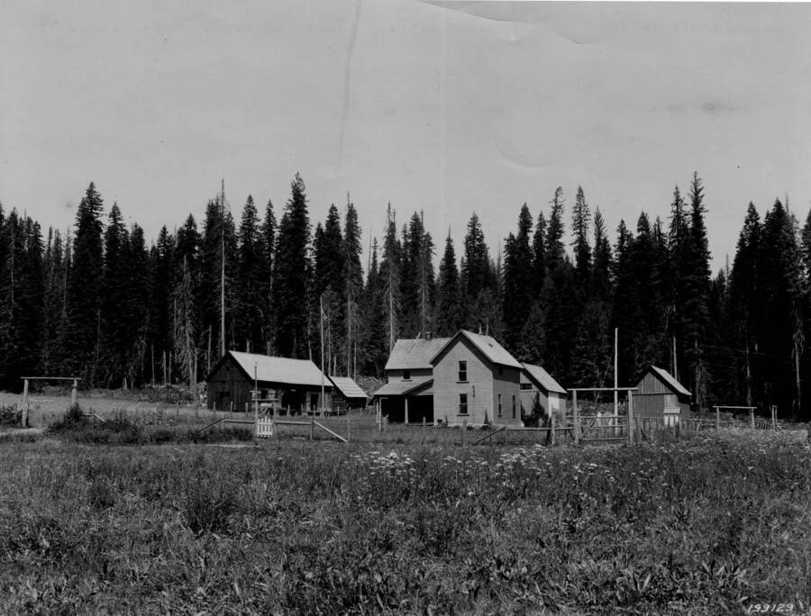 The Musselshell Ranger Station (white building) sits in Musselshell Meadows. Older structures and fences sit around the main building.